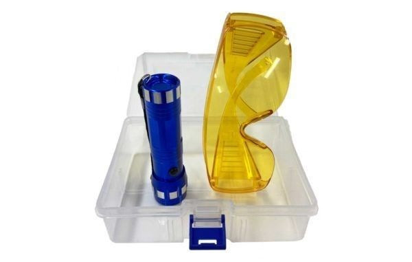 Blue flashlight and yellow safety goggles in a clear plastic box on a white background