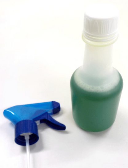 Green spray bottle with blue nozzle