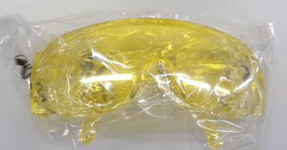 Yellow safety goggles in clear plastic packaging